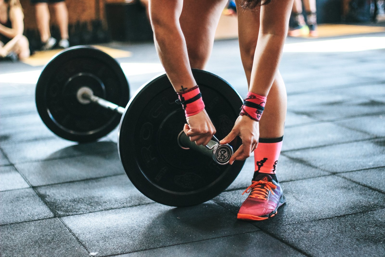 Photo of a person securing the weights on the barbell