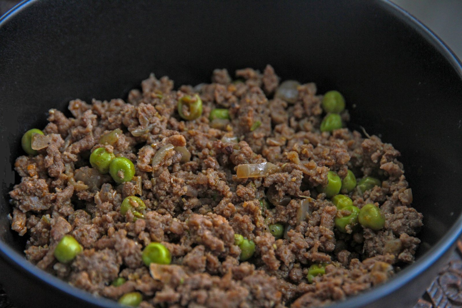 Photo of fatty ground beef in a pan on the stove