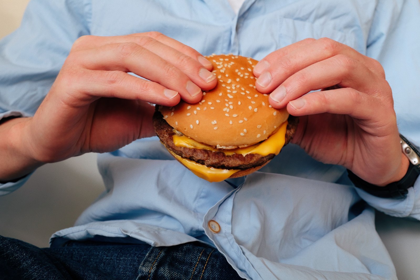 Photo of a person holding a hamburger