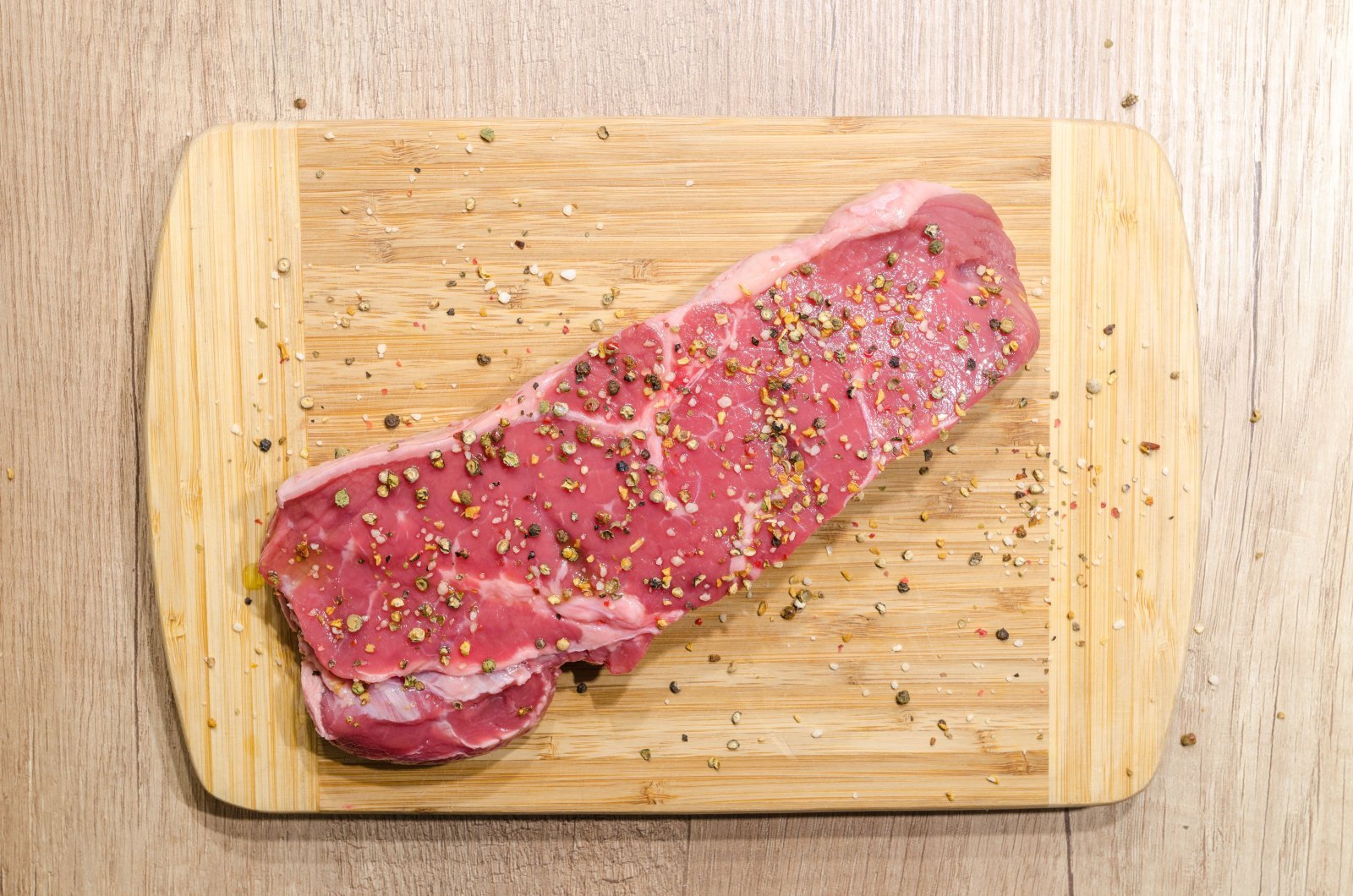 Photo of a raw steak on a cutting board