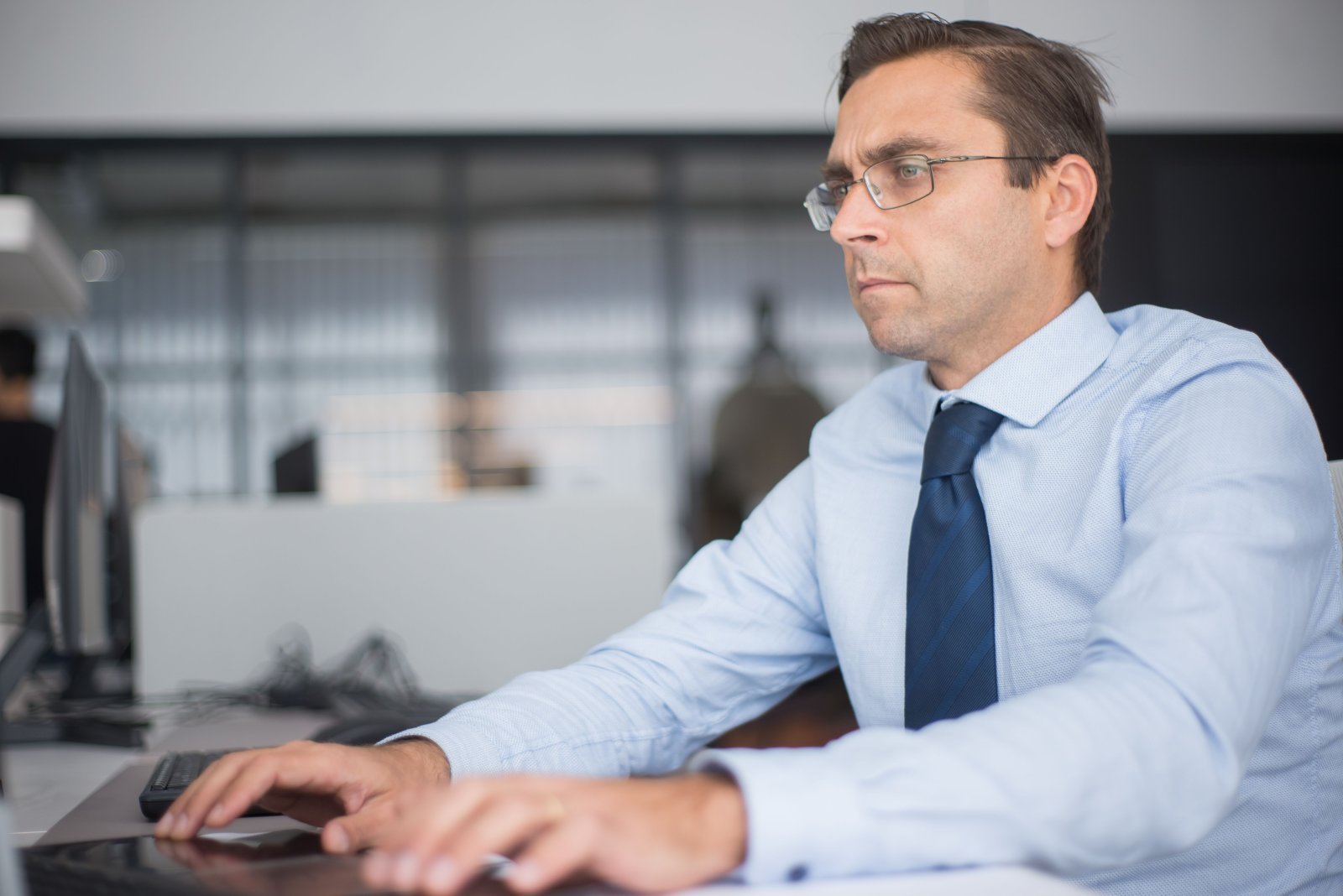 Office worker staring intensely at his computer screen