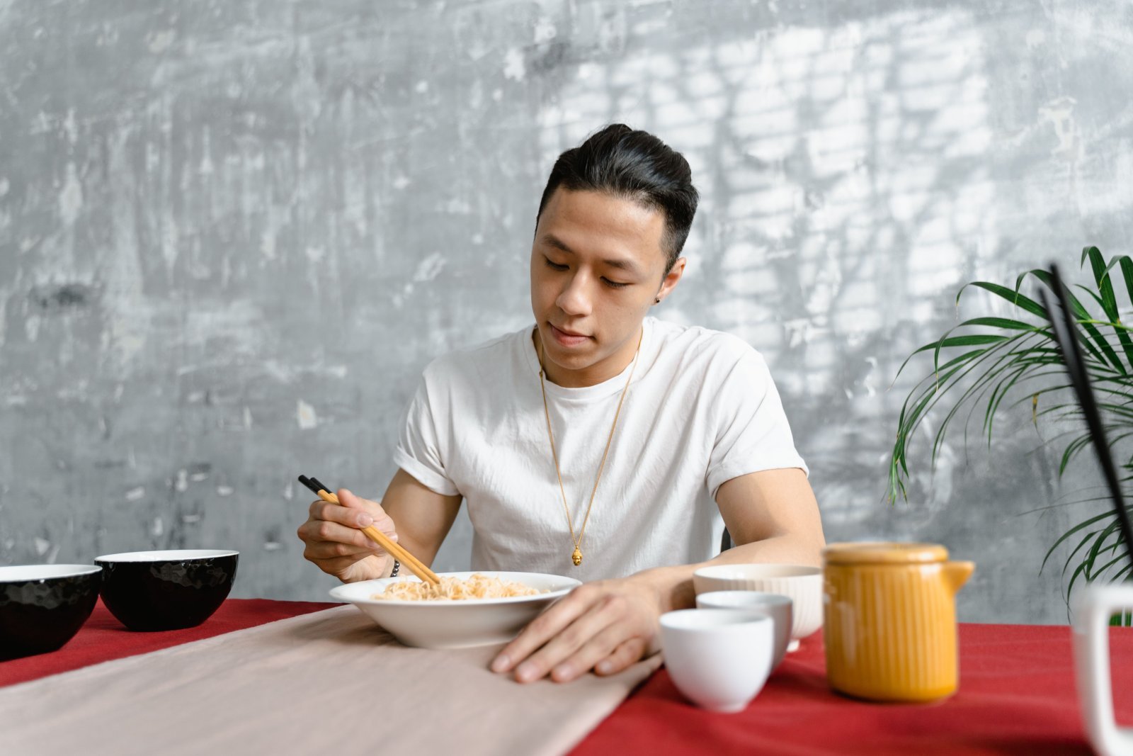 Photo of a man at a table eating food