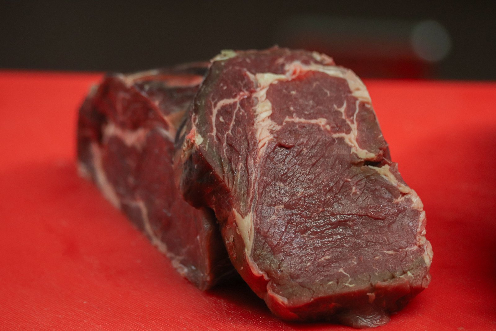Photo of a couple raw steaks on a table