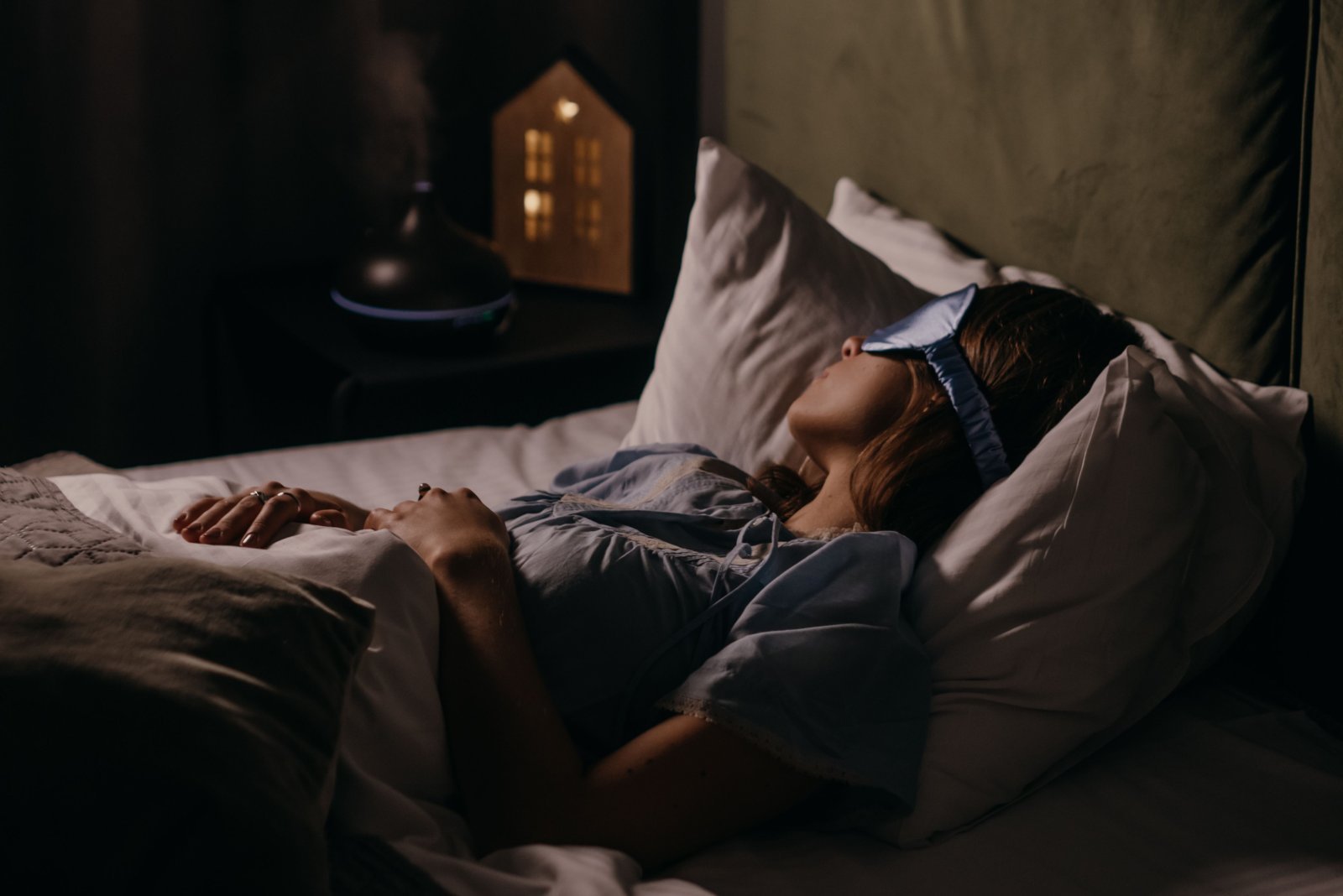photo of a woman sleeping in a dark room