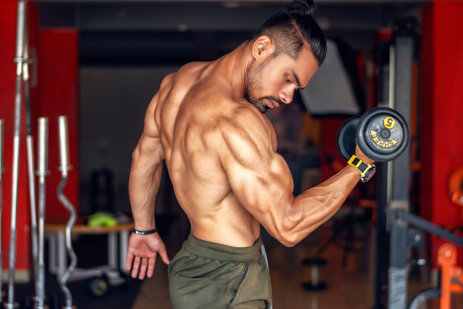 Photo of a muscular man performing bicep curls